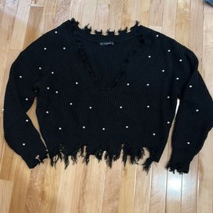 Black sweater with white pearls.